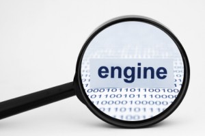 Magnifying glass showing the word engine among a background of zeros and ones